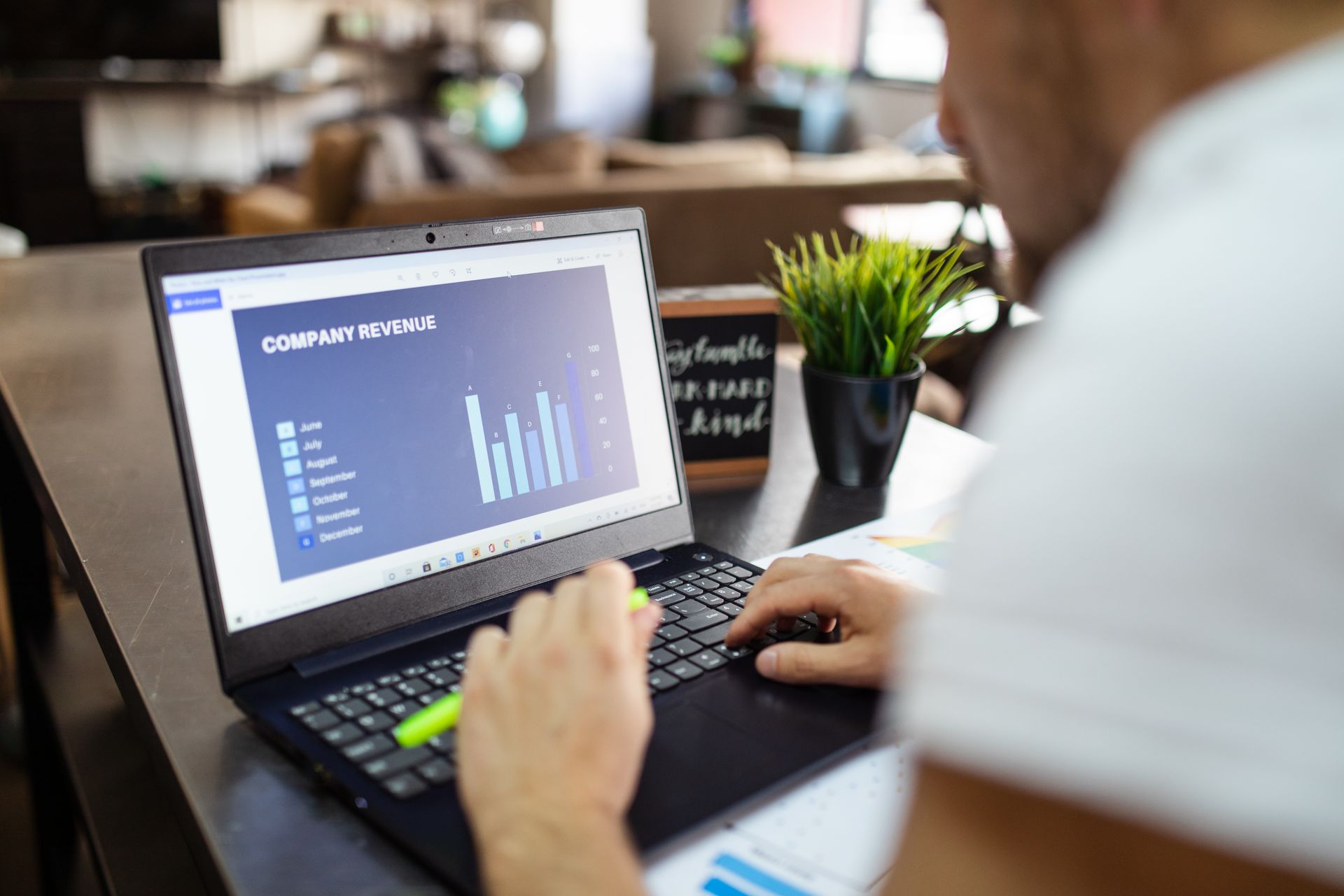 A revenue chart with rising bars on a laptop