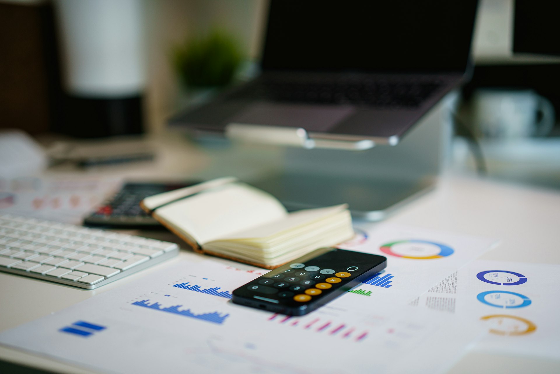 A calculator beside a printed earnings report