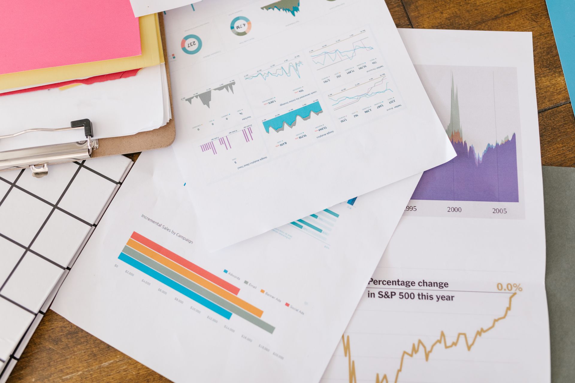 A printed analytics report on a desk with a pen