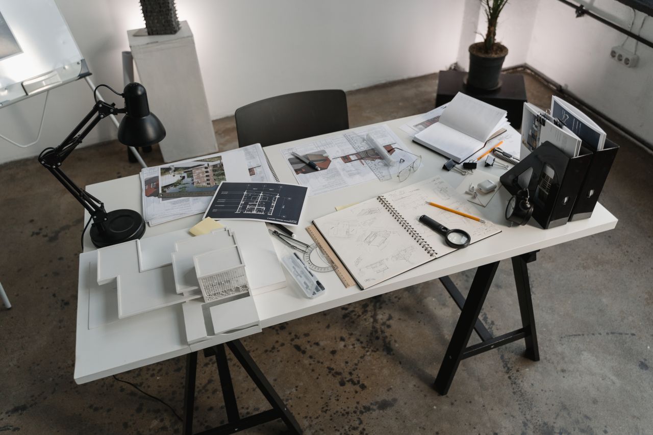 Architectural blueprints spread across a drafting table
