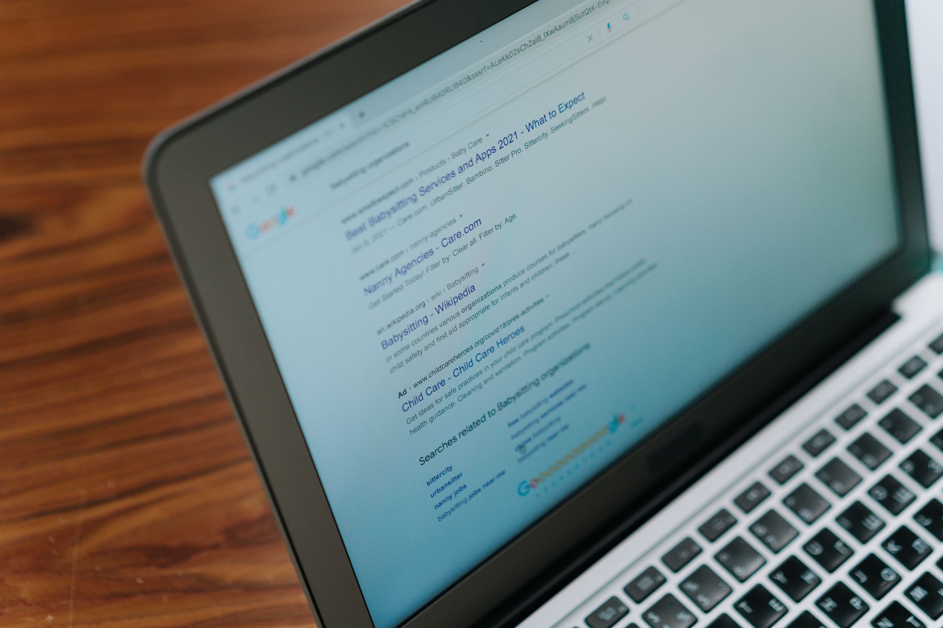 A page of search results open on a laptop