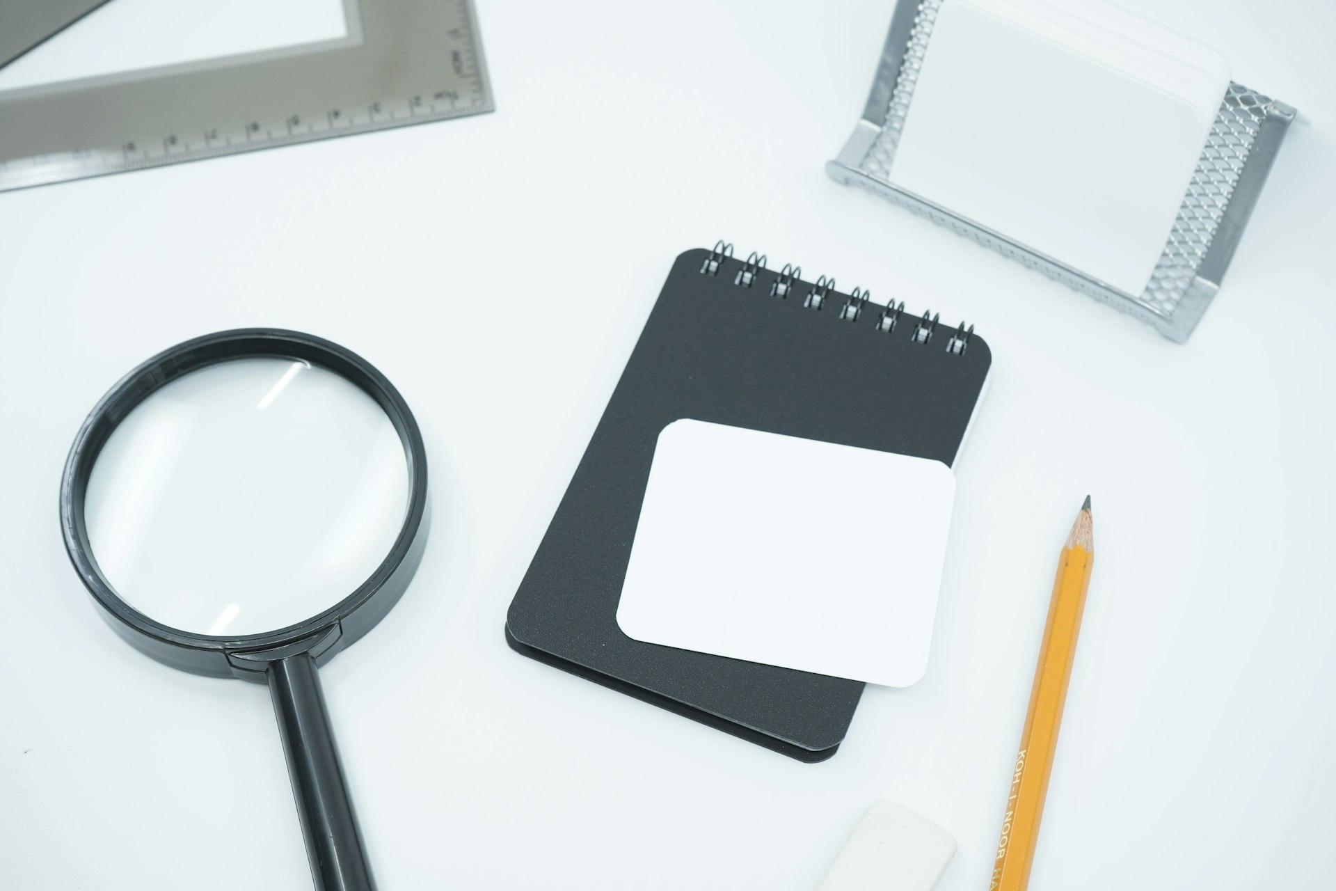 A magnifier resting on a printed product catalogue