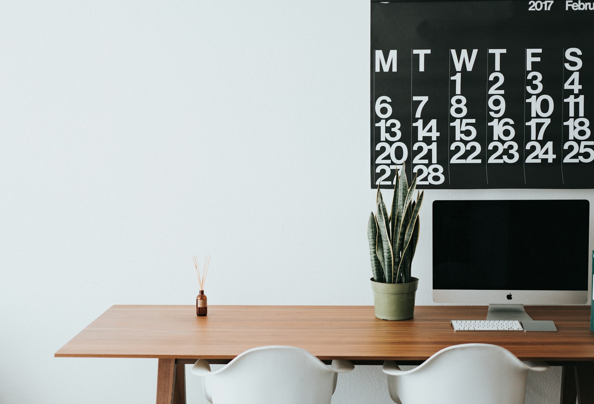 A content plan laid out on a calendar beside a laptop