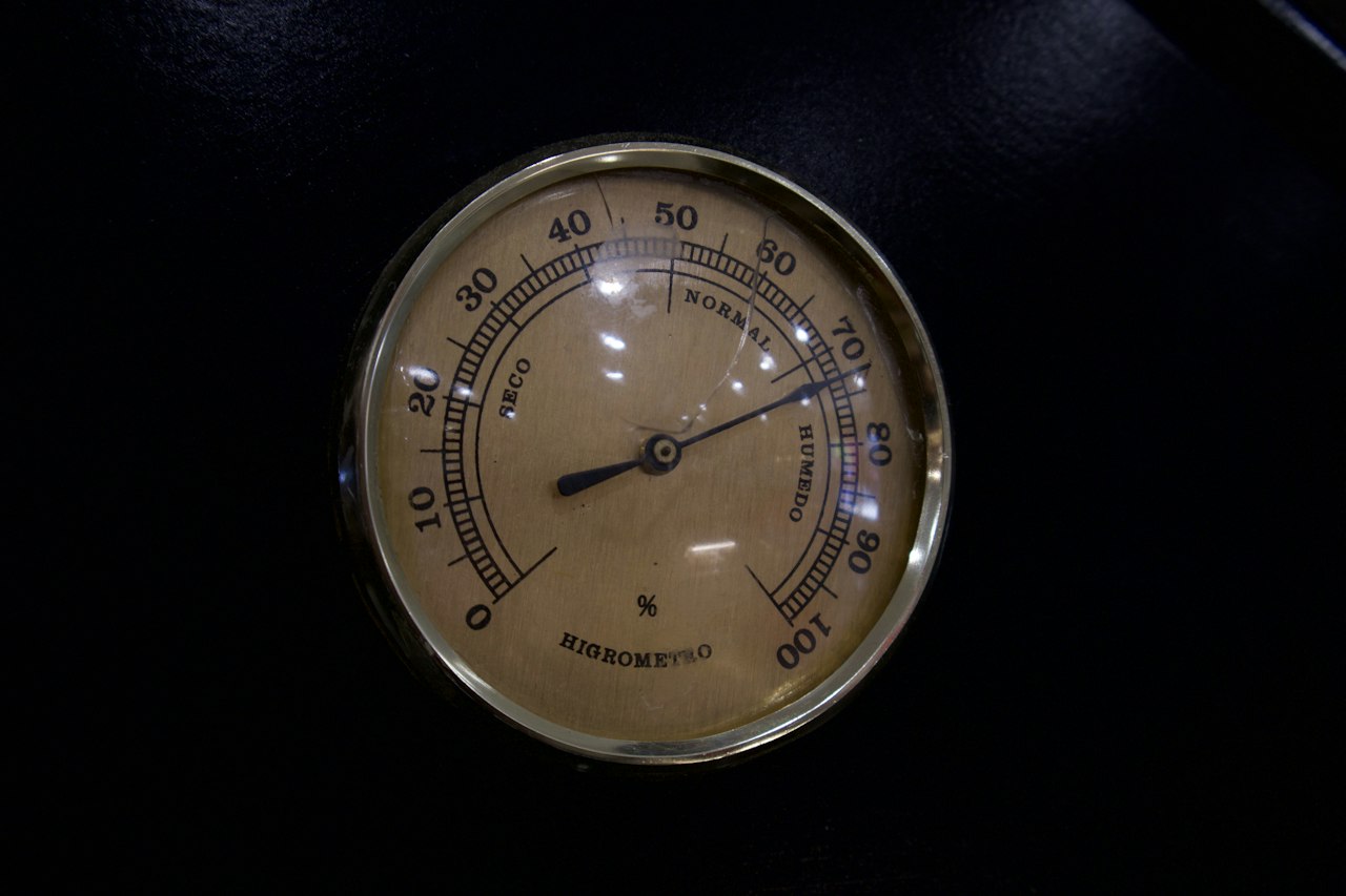 The dial face of a brass barometer