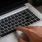 A blogger filling in an ad network application on a laptop