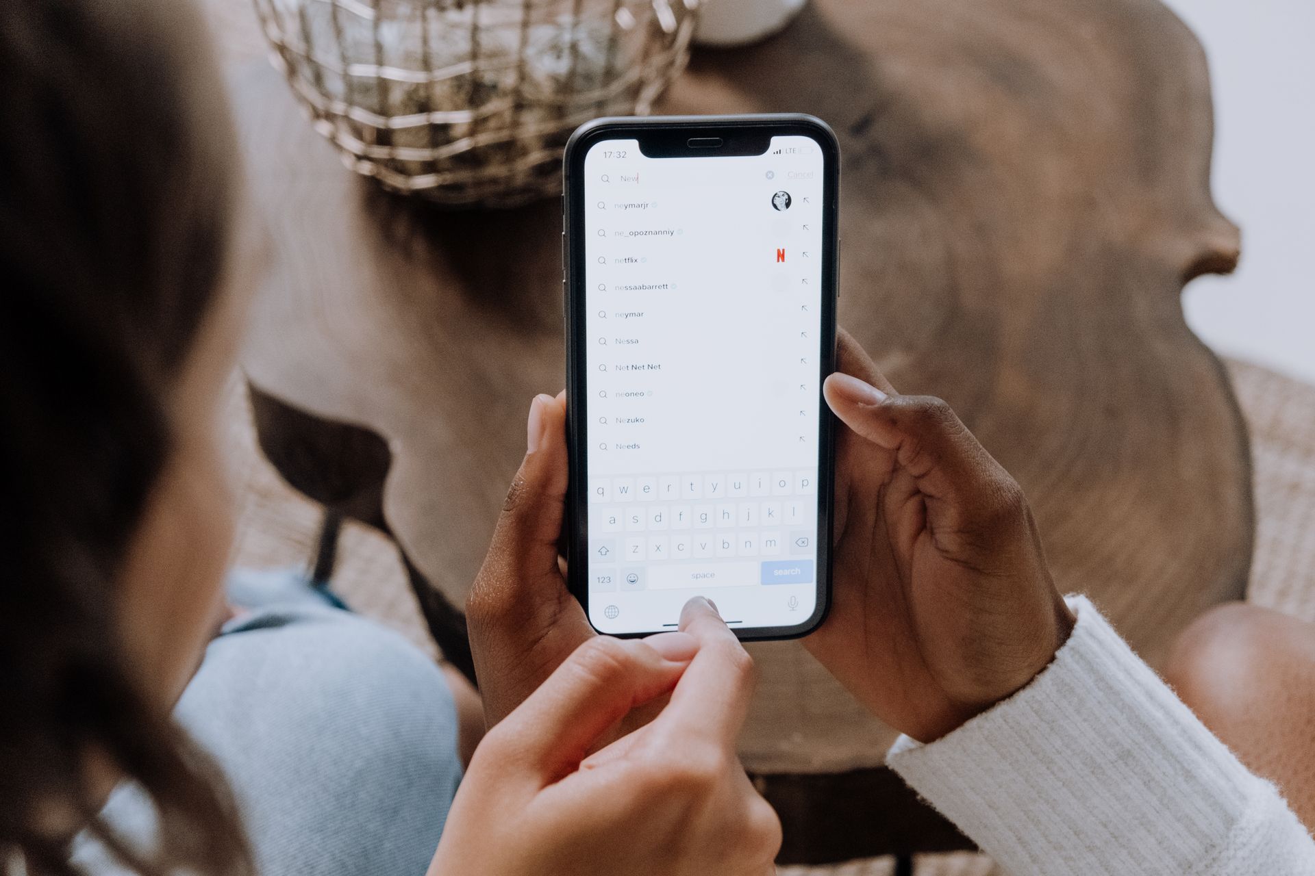 Someone typing a question into search on a phone