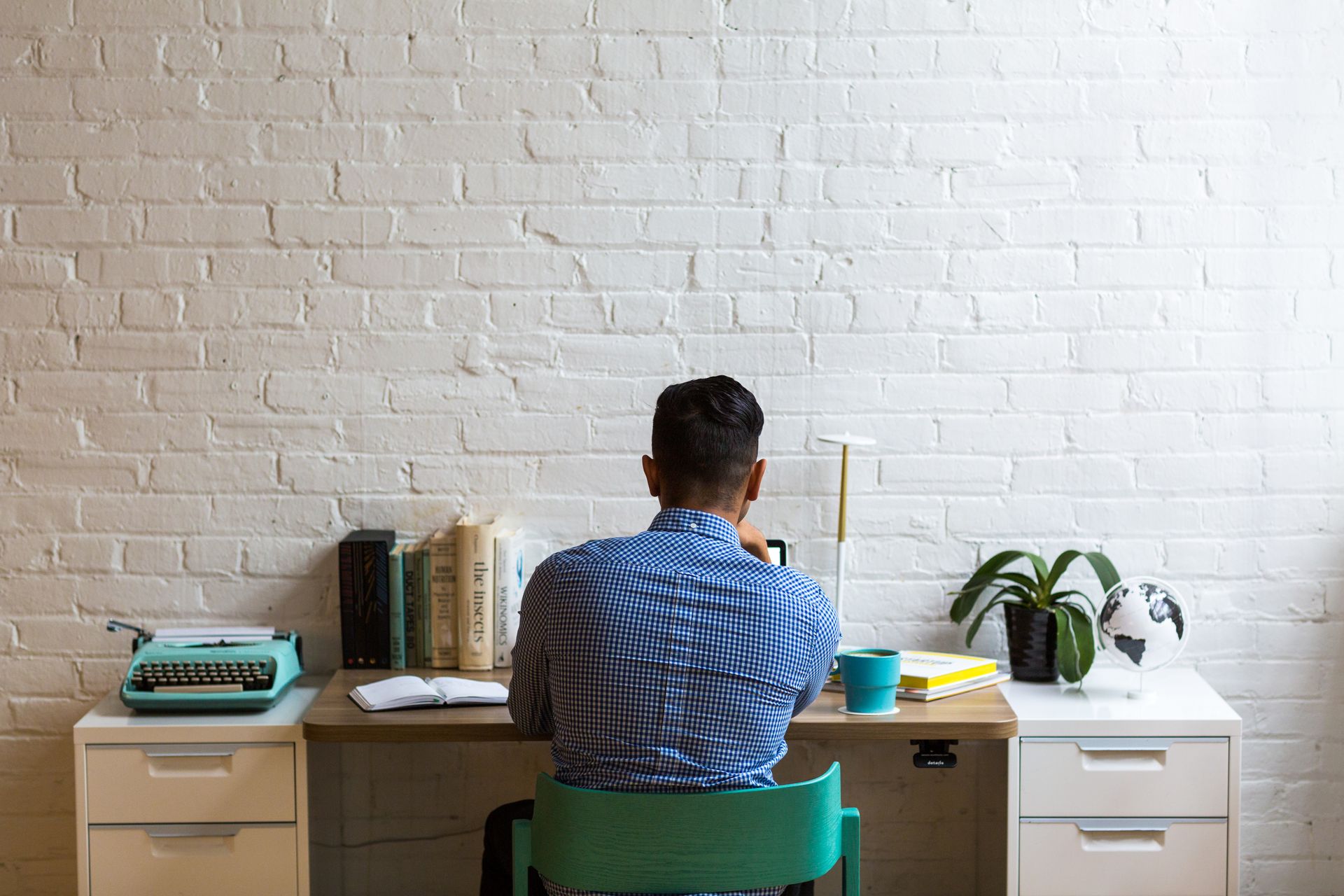 A writer at a desk with products
