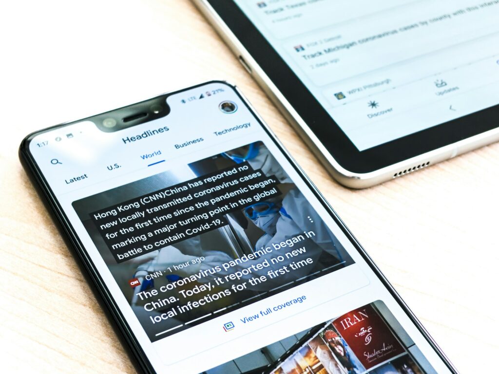 A mobile news article loading on a phone