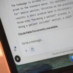A person typing a prompt into an AI chat on a laptop