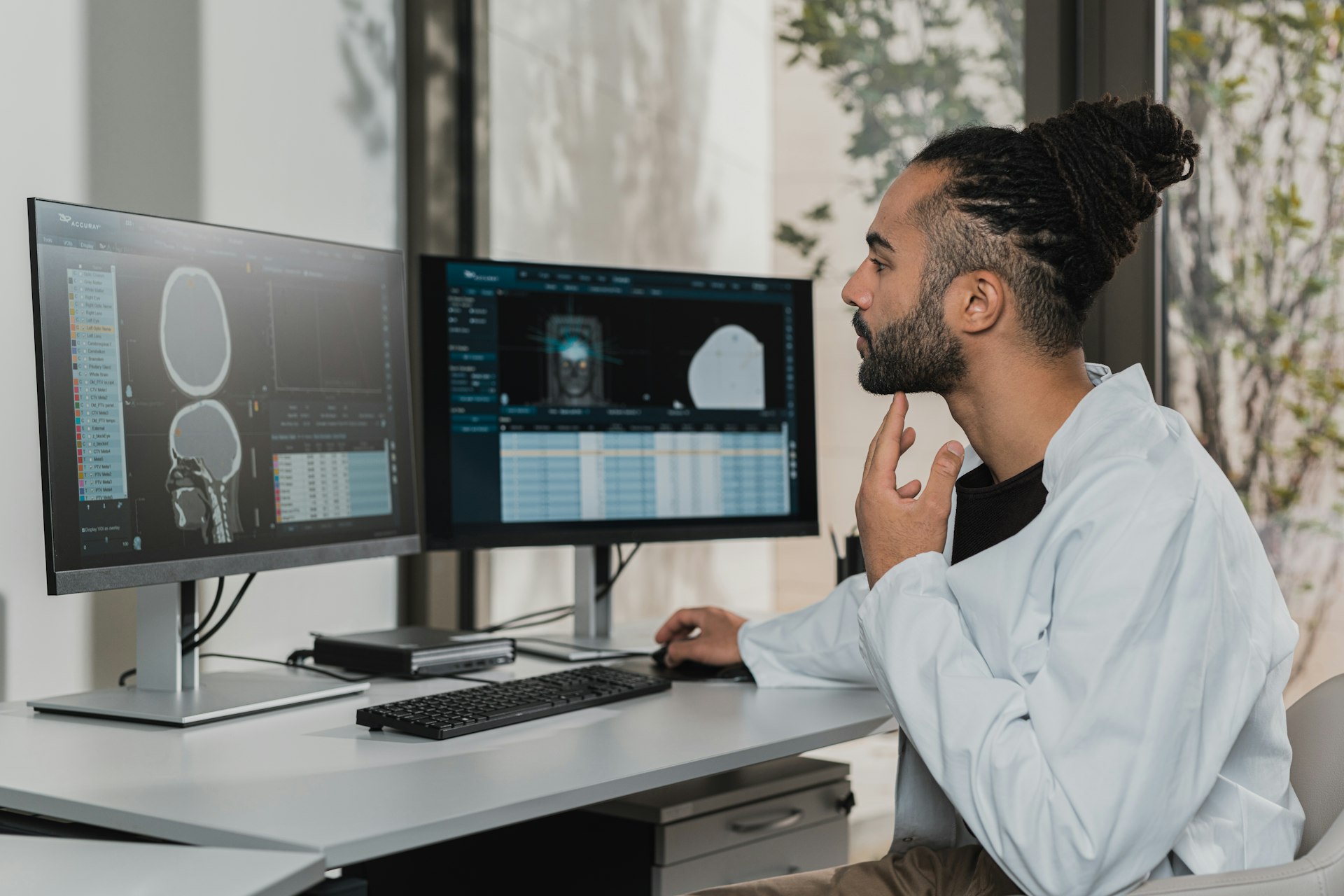 An analyst looking at charts on a monitor