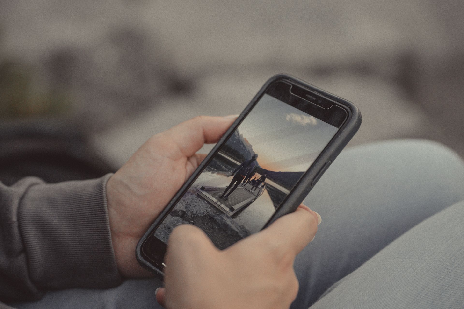 A smartphone in a hand outdoors
