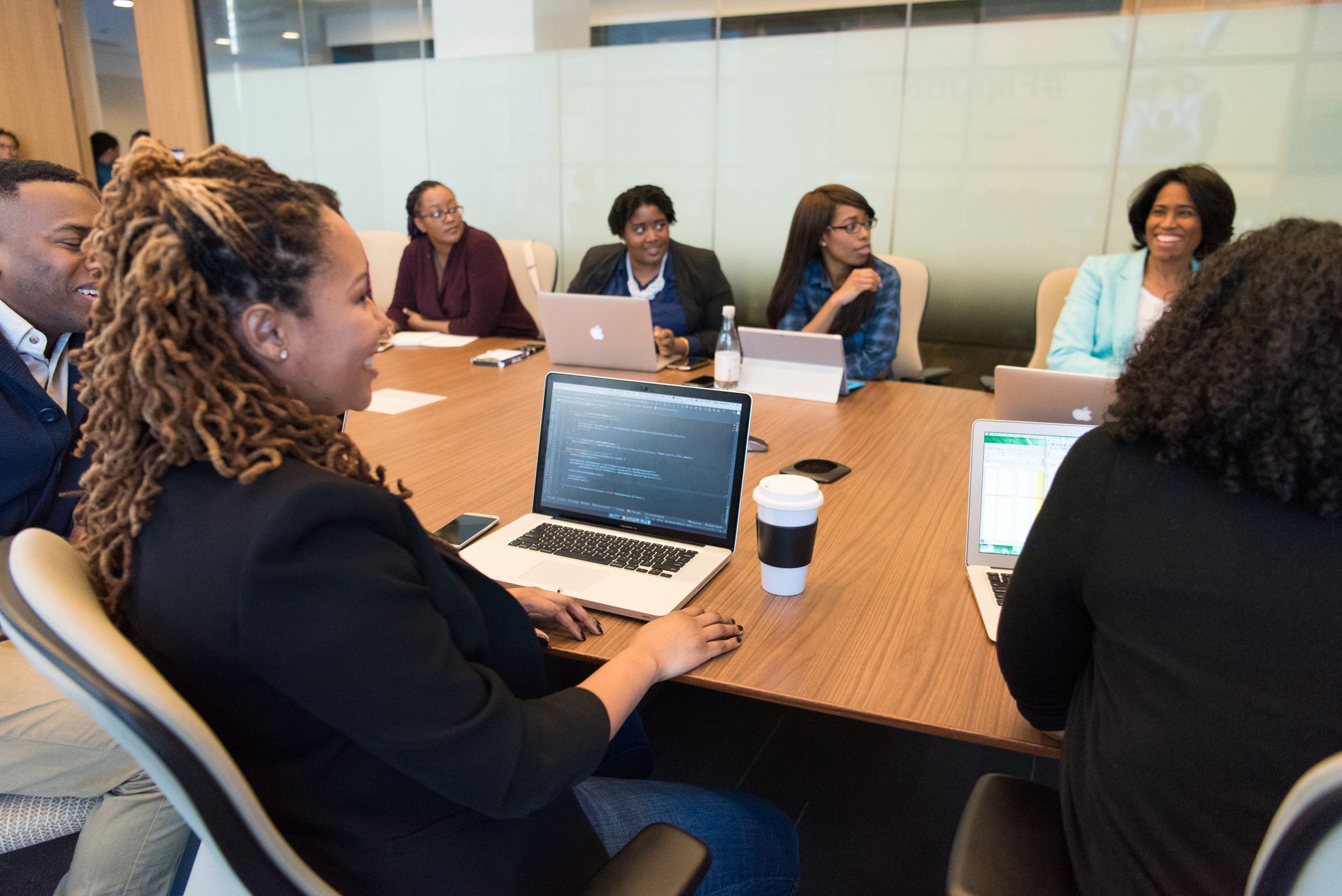 A team meeting around a laptop