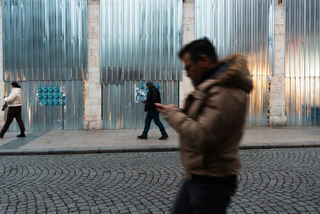 People using phones on a city street