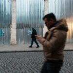 People using phones on a city street