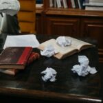A writer reading a brief at a desk