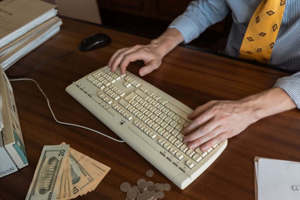 Coins beside a computer mouse