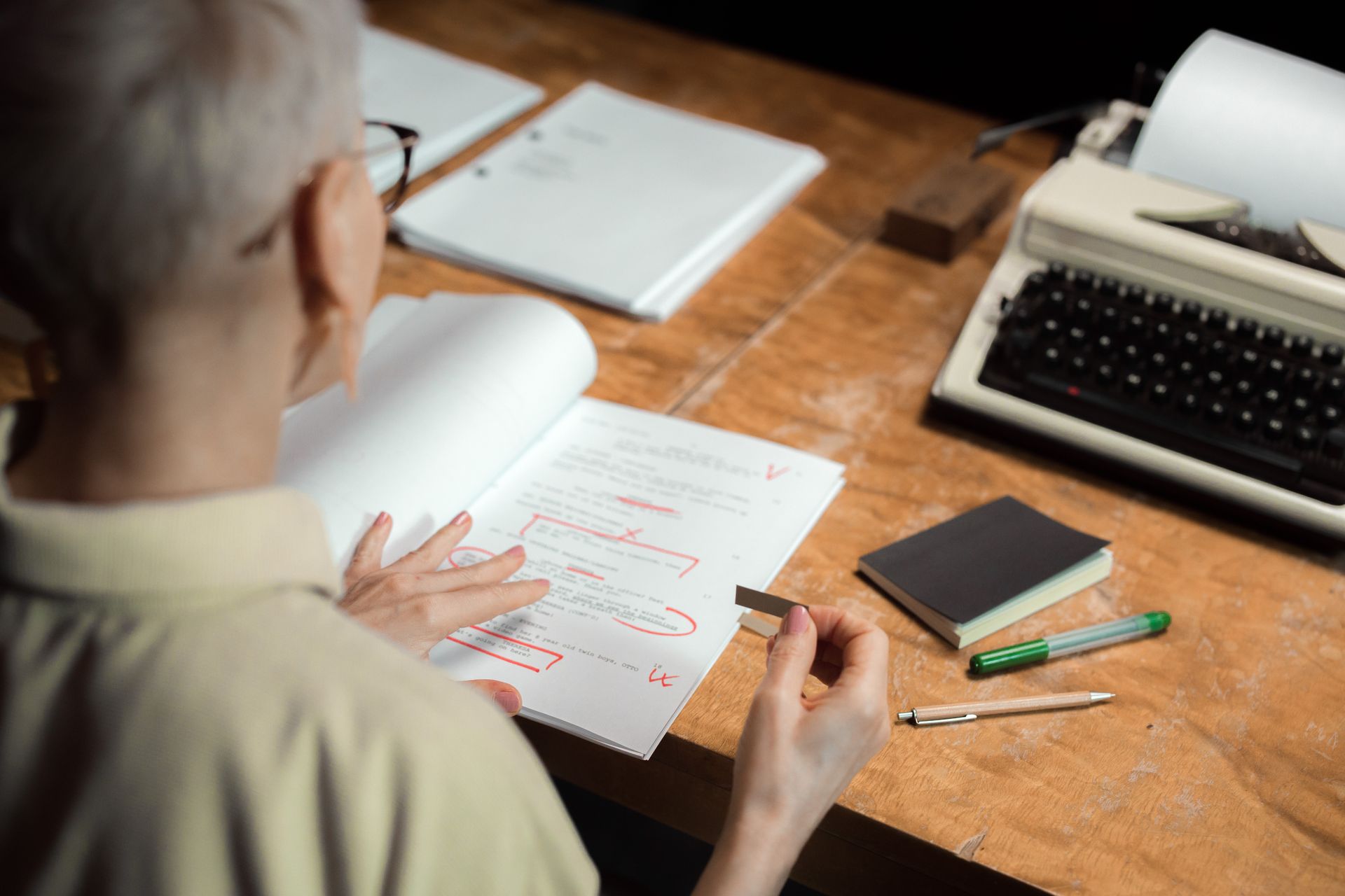 An editor revising a draft with notes