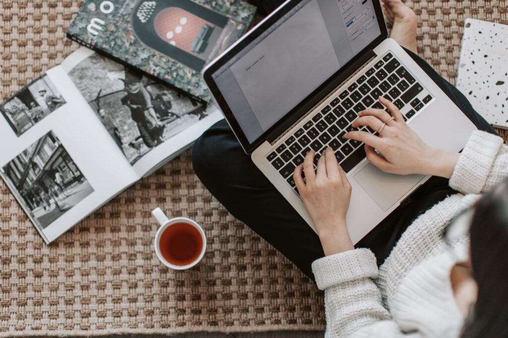 A writer submitting an article on a laptop