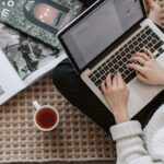 A writer submitting an article on a laptop
