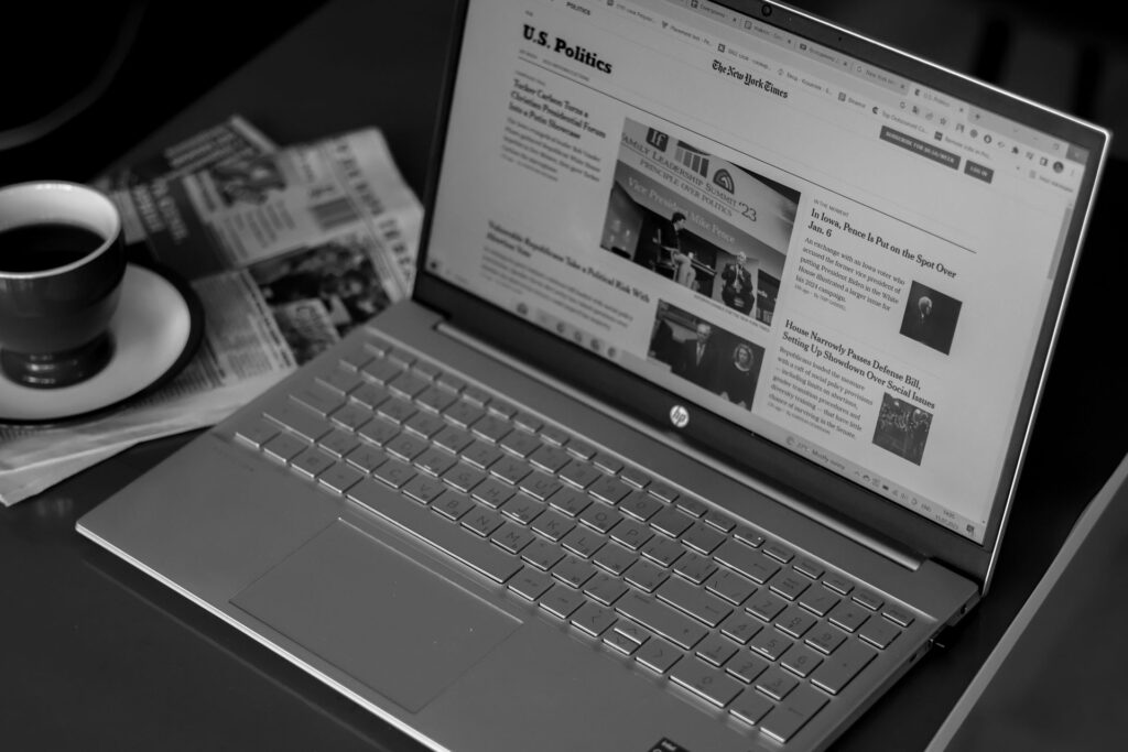 A news website coupon section open on a laptop