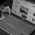 A news website coupon section open on a laptop