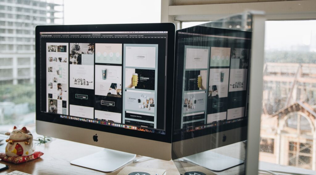 Two near-identical web pages on side-by-side monitors