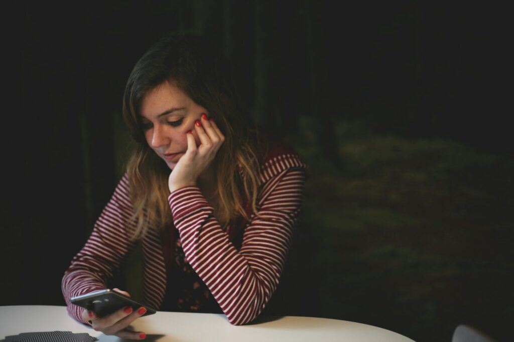 A person on the phone at a laptop