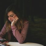 A person on the phone at a laptop