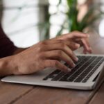 A writer publishing on a laptop
