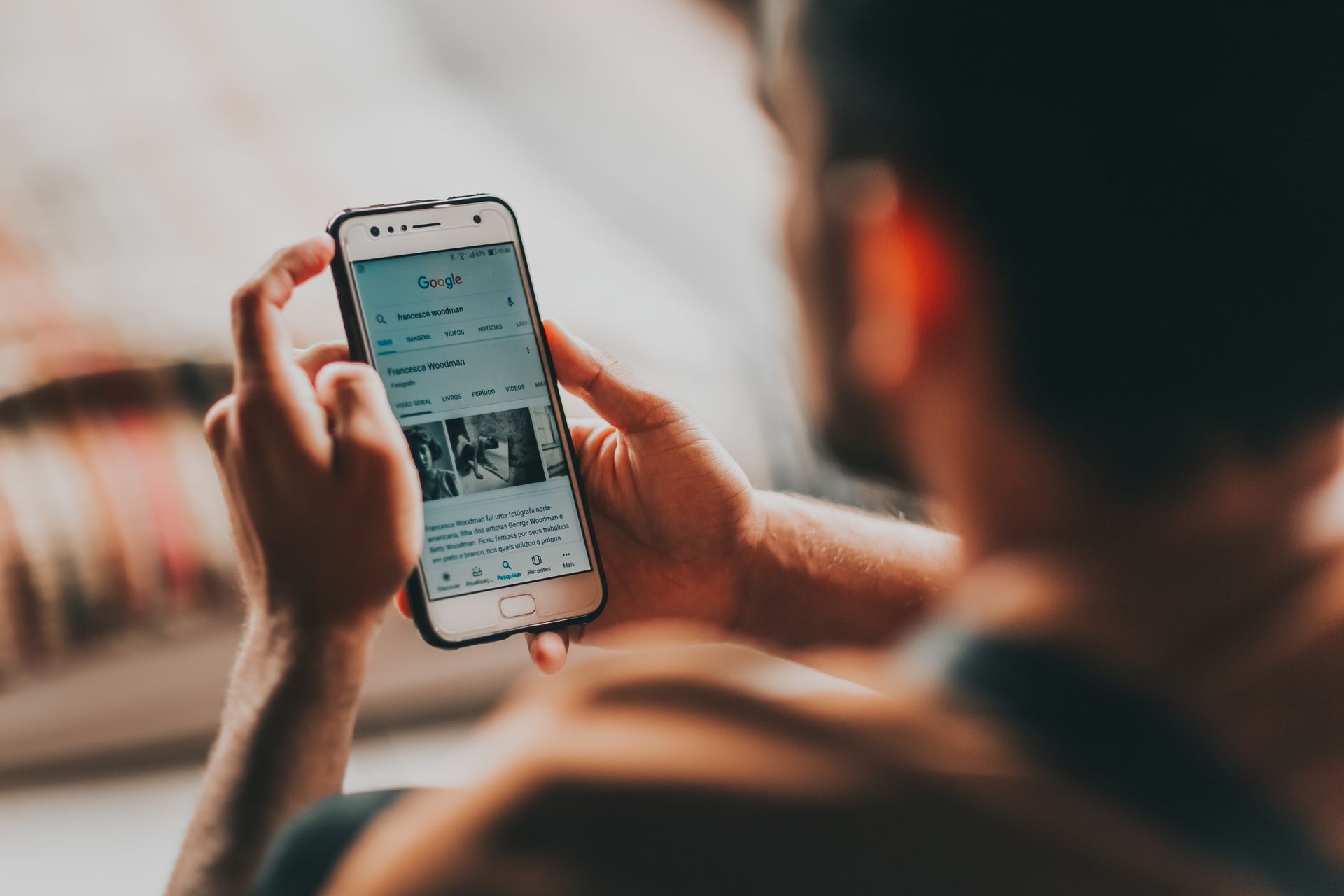 Person scrolling search results on phone