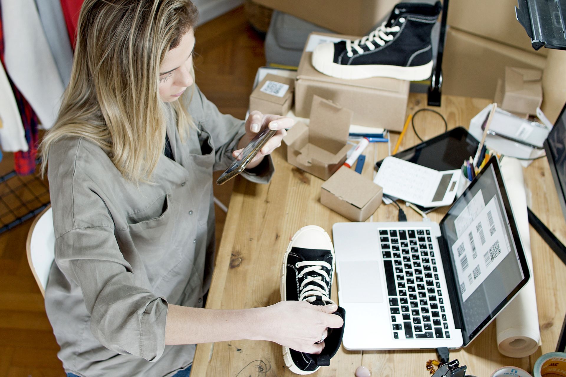 A shop owner at a laptop