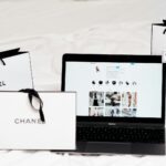 Shopping bags beside a laptop