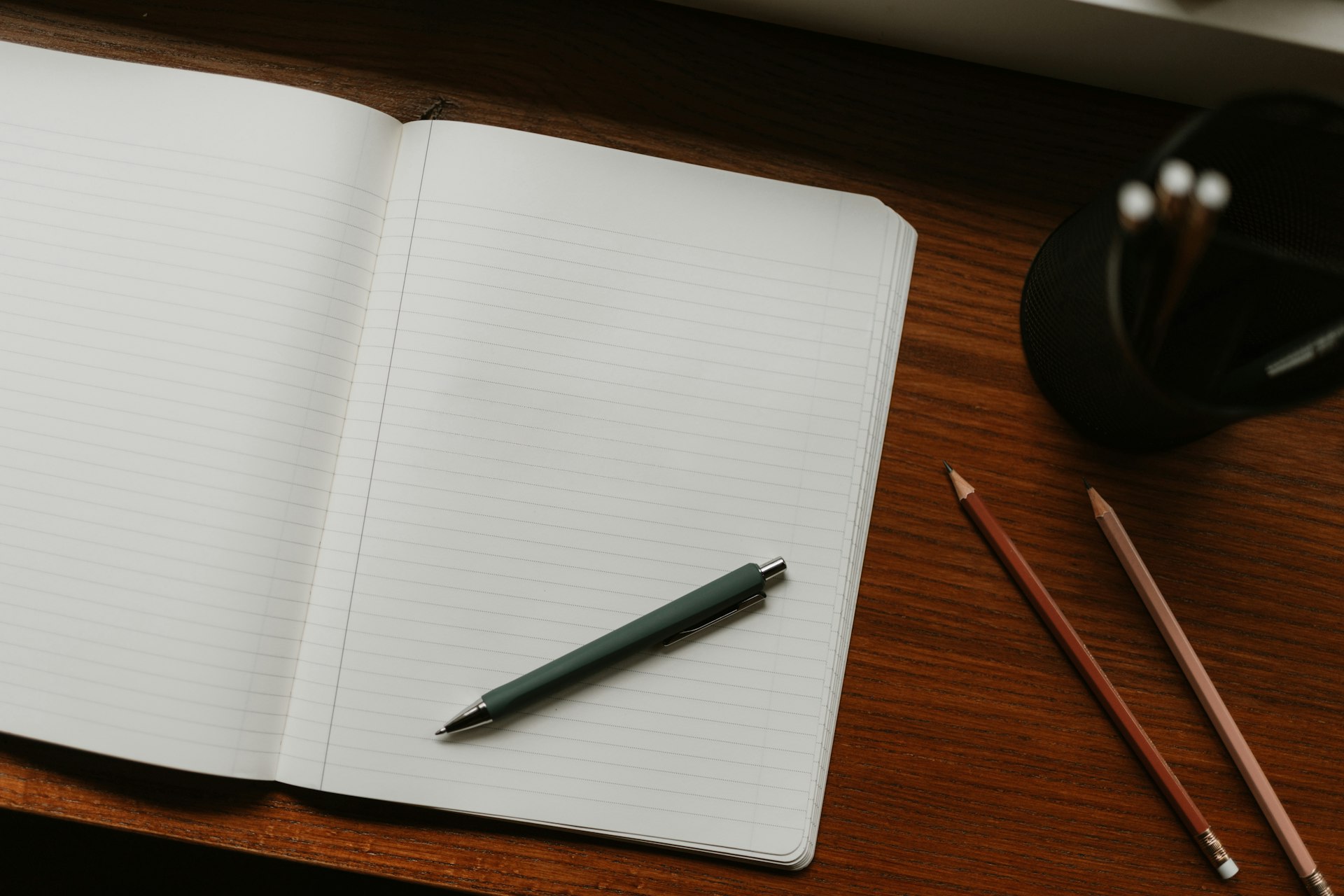 A writer at a desk with a notebook