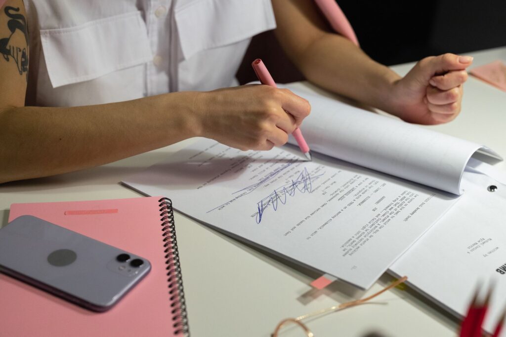 A reviewer testing a product at a desk with notes