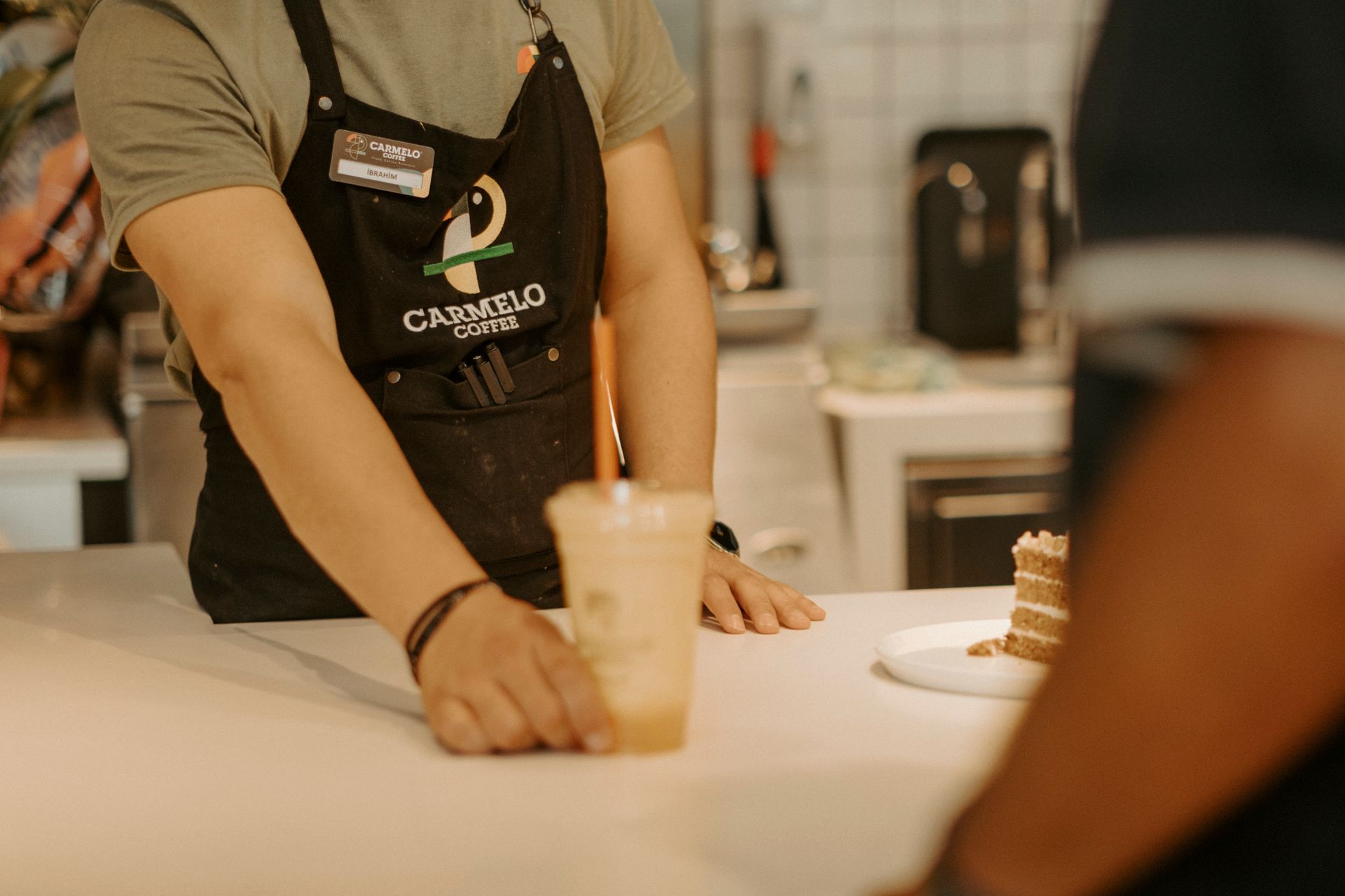 A barista serving coffee