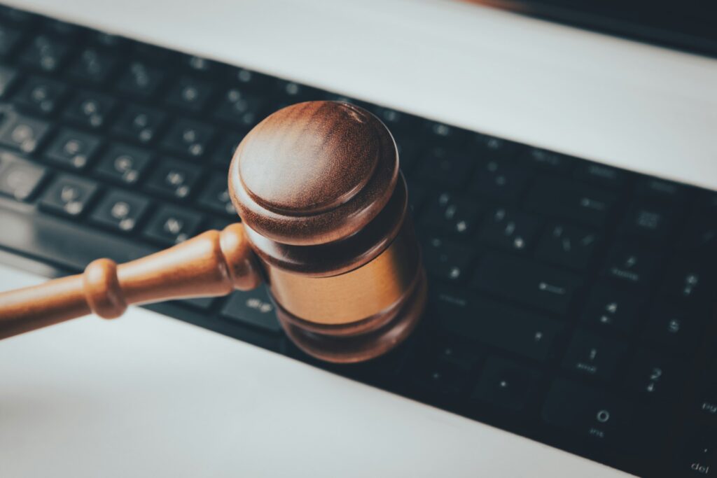 An auction gavel beside a laptop