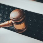 An auction gavel beside a laptop