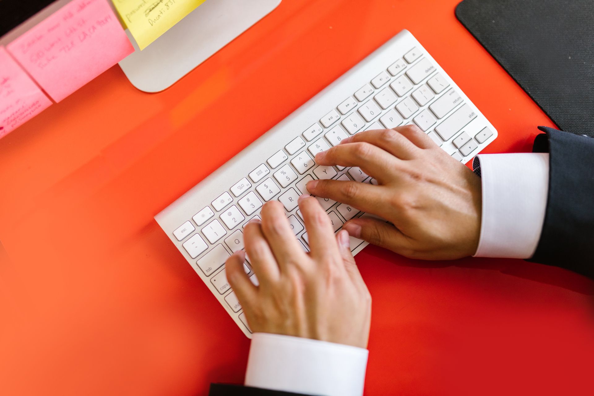 A person typing an amount on a laptop