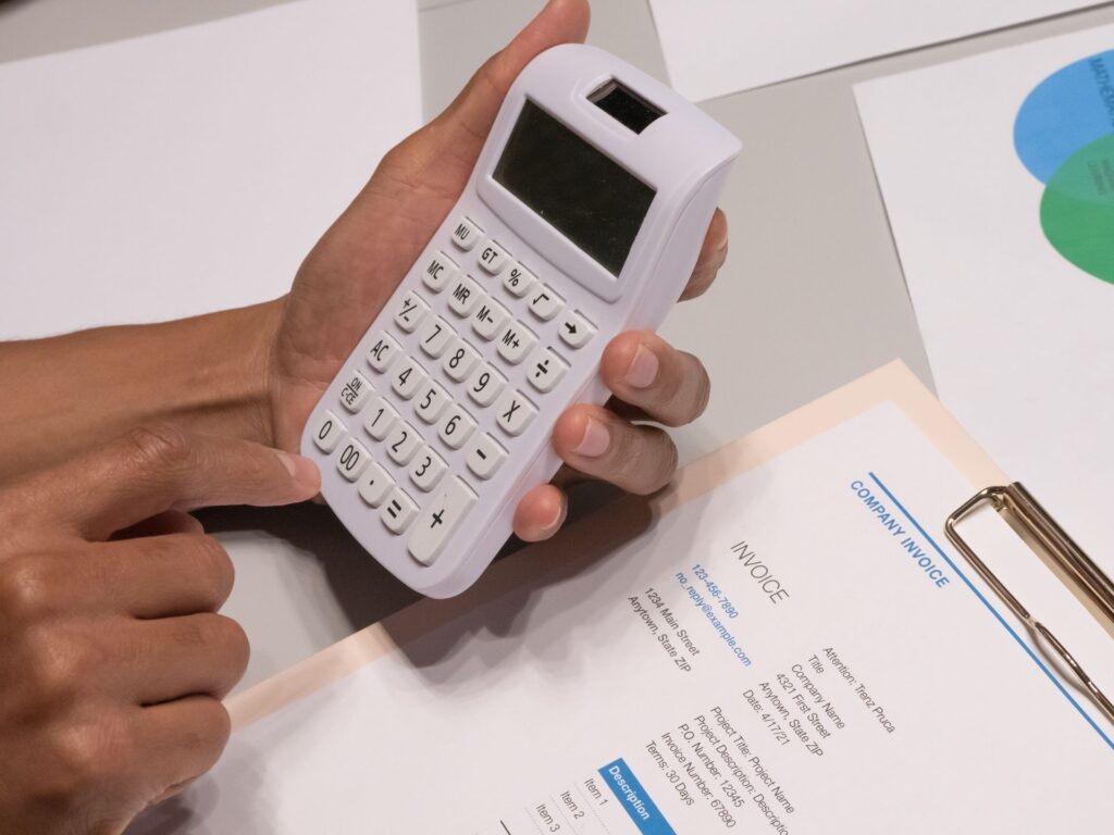 An invoice and a calculator on a desk