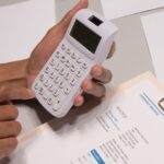 An invoice and a calculator on a desk