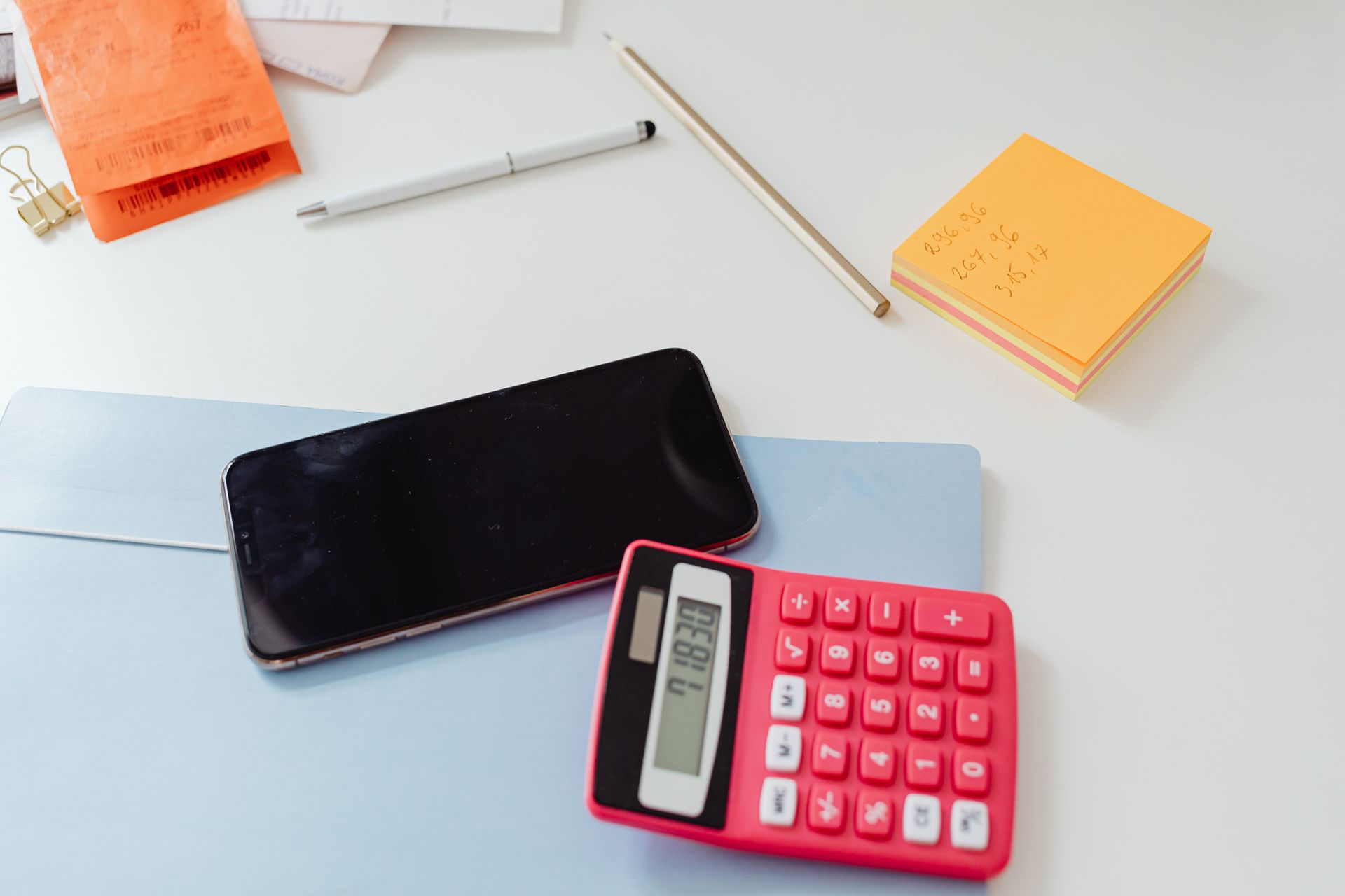 A calculator and notes on a desk