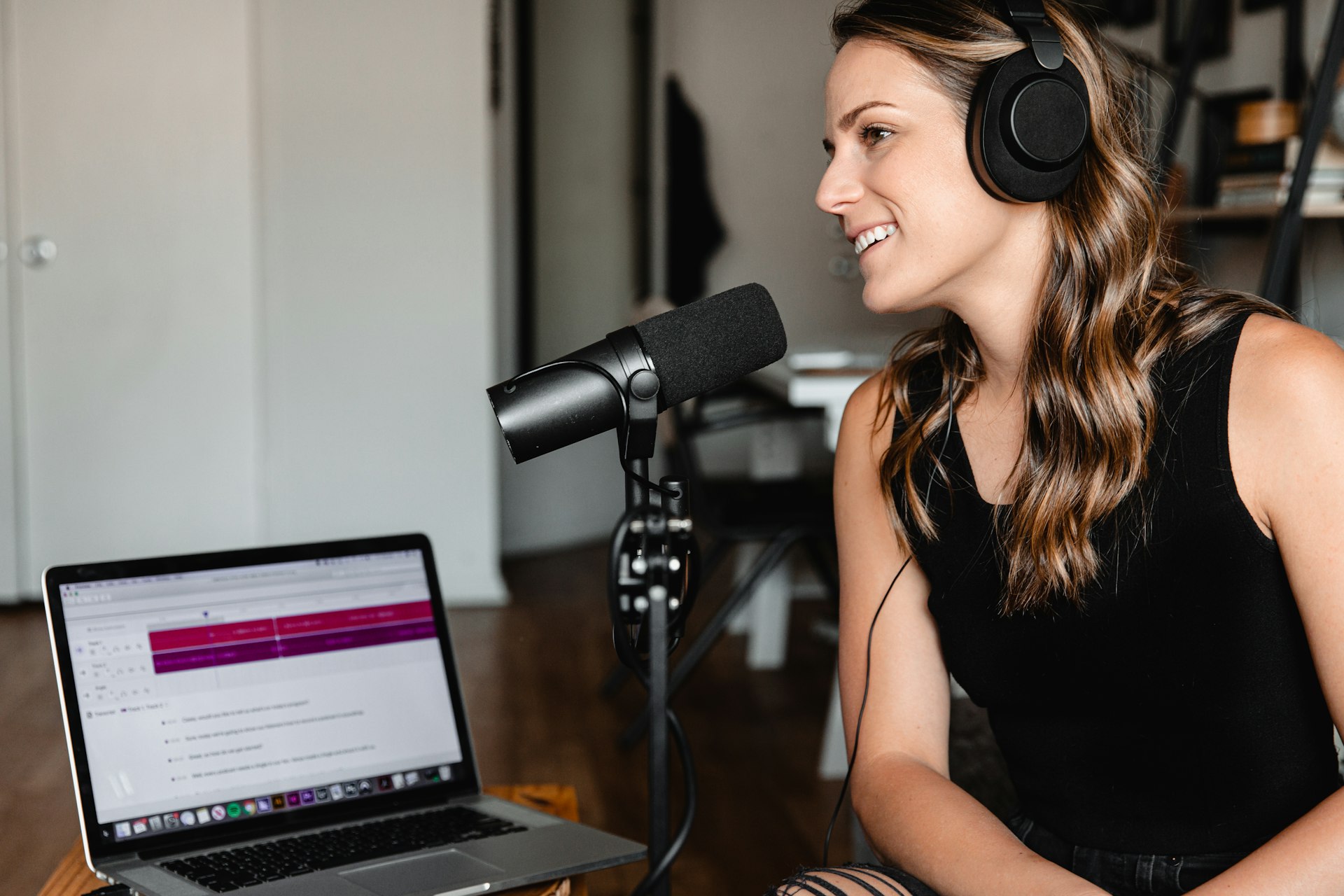 A podcast microphone beside a laptop