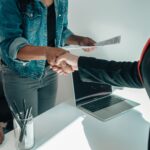 A handshake over a laptop