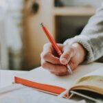 A person writing in a notebook