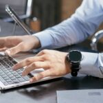 A person filling in a form on a laptop