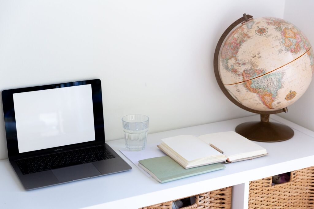 A globe beside a laptop