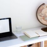 A globe beside a laptop