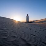 A lighthouse on the coast at dusk