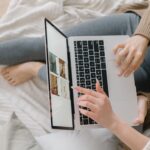 A user clicking a search result on a laptop