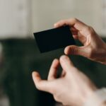 Two hands exchanging business cards